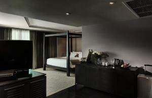 a hotel room with a bed and a television at S15 Sukhumvit Hotel- SHA Extra Plus in Bangkok