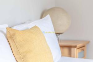 a pillow sitting on top of a bed with a table at PERFECT SPOT IN CENTRAL WINDSOR & FREE PARKING! in Windsor +4 photos
