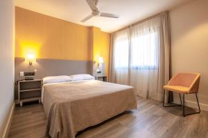 Postel nebo postele na pokoji v ubytování Hotel Zeus