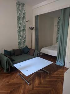 a living room with a couch and a bed at Palais Ophelia in Nice