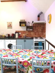 a kitchen with a table with a flowered table cloth at Killarney Saoirse Cottage in Killarney