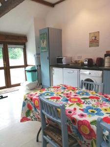 a kitchen with a table with a flowered table cloth at Killarney Saoirse Cottage in Killarney