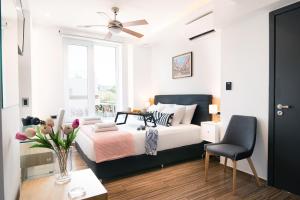 a bedroom with a bed and a table and a chair at Enervillas VIP Villas with pool bbq in Káto Alissós +75 photos
