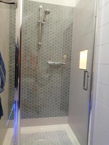 a bathroom with a shower with a glass door at Killarney Saoirse Cottage in Killarney