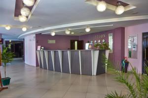a lobby with a reception counter and plants at Pollo Resort in Sunny Beach