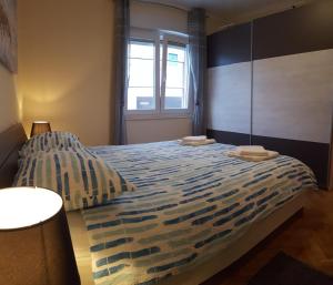 a bedroom with a bed with two towels on it at Harmony apartment in Rijeka