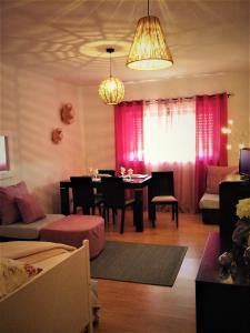 sala de estar con mesa de comedor y cortinas rosas en Ocean View Flat, en Ponta Delgada 43 fotos más
