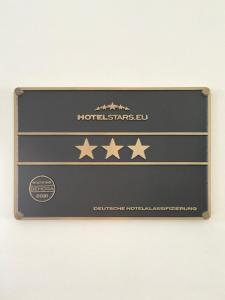 a plaque with four stars on a wall at Concorde Hotel Ascot in Düsseldorf