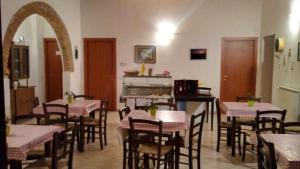 a dining room with tables and chairs and a fireplace at Agriturismo I due Falcetti in Castelfiorentino