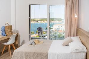 a bedroom with a bed and a view of the ocean at RVHotels Nieves Mar in L'Escala