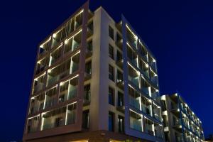 a tall white building at night at RVHotels Nieves Mar in L'Escala