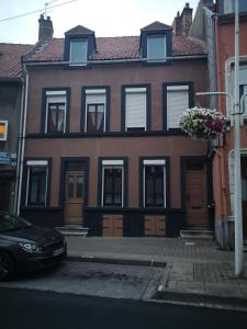 a house with a car parked in front of it at Une affaire de famille in Le Portel