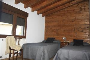 Un pat sau paturi într-o cameră la Casa Rural Avellaneda