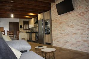 a living room with a couch and a brick wall at Casa Rural Avellaneda in Avellaneda