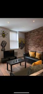 a living room with a couch and a coffee table at Spacious Shude Hill Apartment With Balcony in Manchester