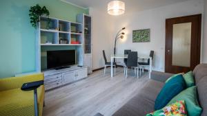 een woonkamer met een bank en een tafel met stoelen bij Italianway - Bersaglio 25 in Udine