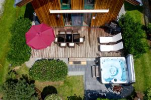 an overhead view of a patio with a hot tub and umbrella at Luxury Chalet Kreischberg 11a in Sankt Lorenzen ob Murau