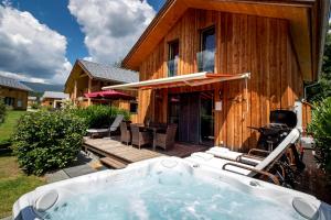 a hot tub in front of a wooden house at Luxury Chalet Kreischberg 11a in Sankt Lorenzen ob Murau +86 photos