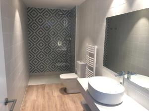 a bathroom with a toilet and a sink and a mirror at RVHotels Nieves Mar in L'Escala
