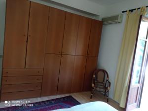 a bedroom with large wooden cabinets and a chair at Villa Strazzeri in Palermo