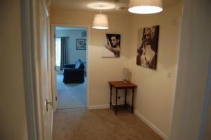 a hallway with a room with a table and pictures on the wall at 18A Milford Street in Salisbury