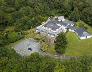 a large building with a lot of trees on the side of it at Carreg Bran in Llanfairpwllgwyngyll