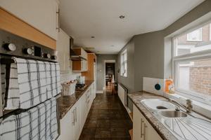 a large kitchen with a sink and a window at No 7 Gray Street in Lincoln