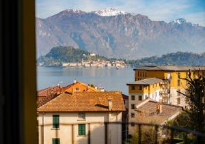 a view of a city and a lake and mountains at Griante suites in Griante Cadenabbia