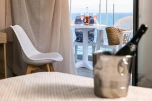 a bottle of wine sitting on a table next to a window at RVHotels Nieves Mar in L'Escala