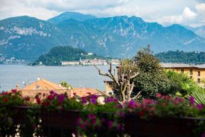 a view of a city and a body of water with mountains at Griante suites in Griante Cadenabbia