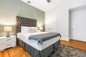 a bedroom with a large bed with a large headboard at Stunning Modern and Fully-Upgraded 5 BR w Pool in New Orleans