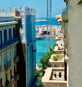 a view of the water from between buildings at Guesthouse City Center in Bari