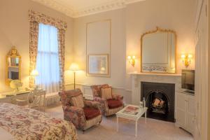 a hotel room with a bed and a fireplace at The Merrion Hotel in Dublin +41 photos