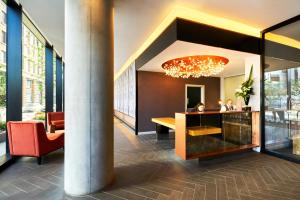 a lobby of a building with a chandelier at CitySuites Aparthotel in Manchester