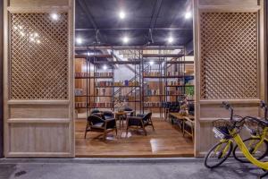 a room with a table and chairs and bookshelves at The Chic Lipe in Ko Lipe