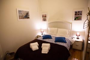 a bedroom with a large bed with blue and white pillows at Amazing river view in historical Lisbon in Lisbon
