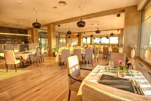 a dining room with tables and chairs in a restaurant at Hotel Vinice Hnanice in Hnanice