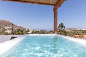 a swimming pool with a view of the mountains at Thea Suites Naxos in Agios Prokopios