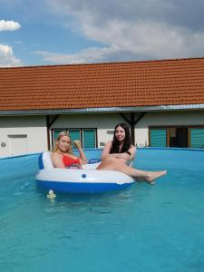 two women are sitting on an inflatable at Apartment Rappitsch in Sankt Marein bei Knittelfeld