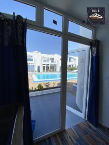 a sliding glass door with a view of a swimming pool at Cristian Puerto del Carmen Los Delfines in Puerto del Carmen