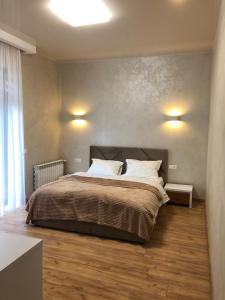 a bedroom with a large bed with two pillows at Апартаменти КАРПАТИ in Karpaty