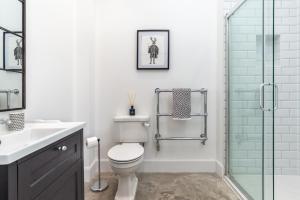 a bathroom with a toilet and a glass shower at The Cart Shed in Laurencekirk