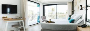 a bedroom with a bed and a large window at Hotel Almirante in Alicante