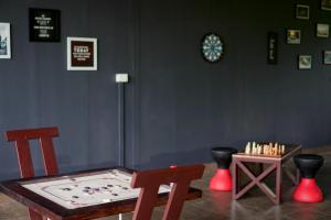 a room with a table and chairs and a chessboard at IRON BRIDGE COVE in Meppādi
