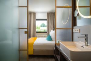 Letto o letti in una camera di Hetzel Hotel Stuttgart