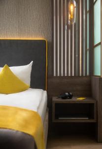 Letto o letti in una camera di Hetzel Hotel Stuttgart