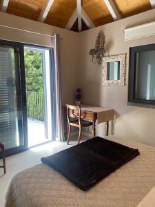 a bedroom with a desk and a bed and a table at Casa de Prazeres in Prazeres +187 photos