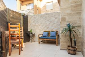 a patio with a blue chair and a plant at סטודיו 10 studio in Eilat