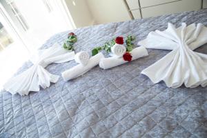a bed with three white dresses and flowers on it at The Era Otel in Gölhisar +29 photos