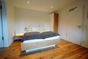 a bedroom with a bed with a wooden bed frame at Blekkers Bed&Breakfast in Uelsen